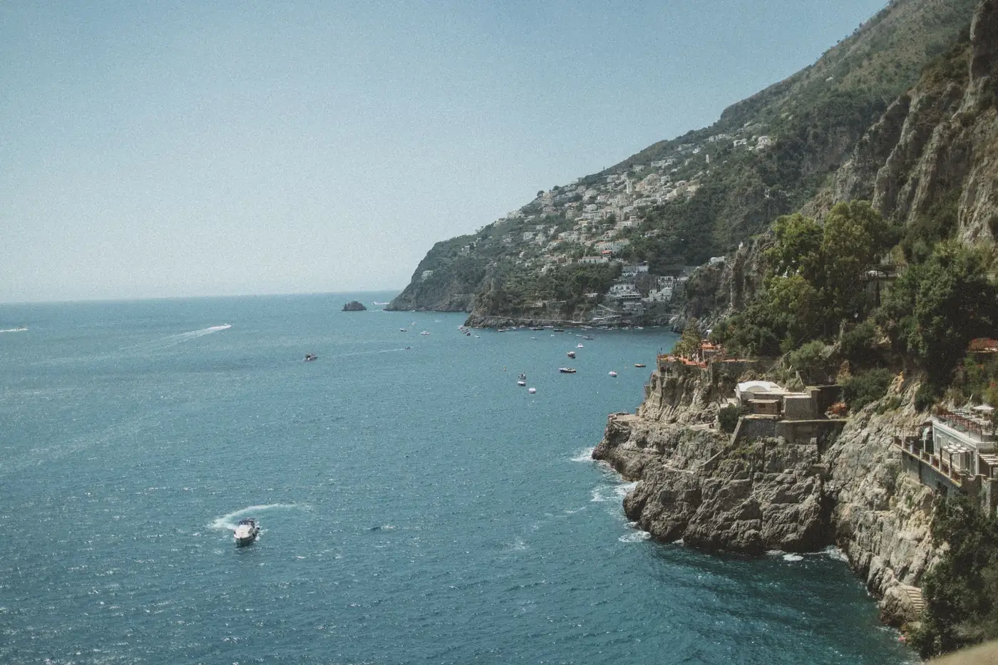 A cliffside village above a turquoise bay on the Amalfi coast, Italy